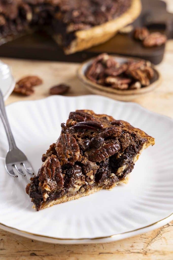 A slice of chocolate pecan pie on a plate.